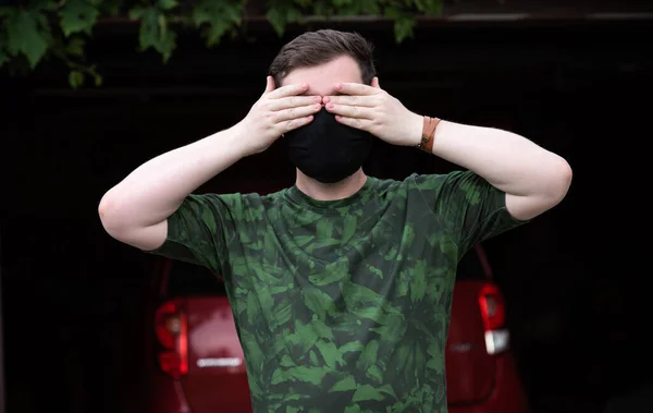 Social distance. Stop virus ! Young Man in Textile black cotton mask