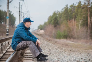 Demiryolundaki hayatını düşünen kıdemli bir adam. Olgun erkek psikolojisi.