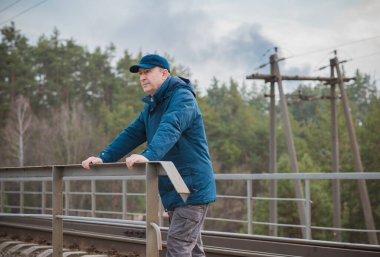 Demiryolundaki hayatını düşünen kıdemli bir adam. Olgun erkek psikolojisi.