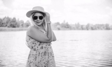 Çekici ve cüsseli genç bayan doğada dinleniyor. Şık giyinmiş genç bir kadının portresi.