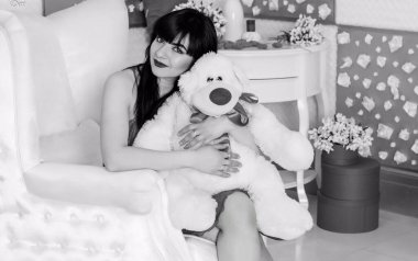 Ev konforu kavramı. Evde İspanyol görünümlü bir kadın güzel bir öğleden sonranın ya da akşamının tadını çıkarır.