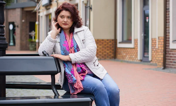 Yetişkin, iri yapılı, Amerikan ya da Avrupa görünümlü basit bir kadın şehirde hayatın tadını çıkarıyor. Fazla kilolu, ceketli ve fularlı hoş bir bayan şehrin eski bir köşesinde dolaşıyor.