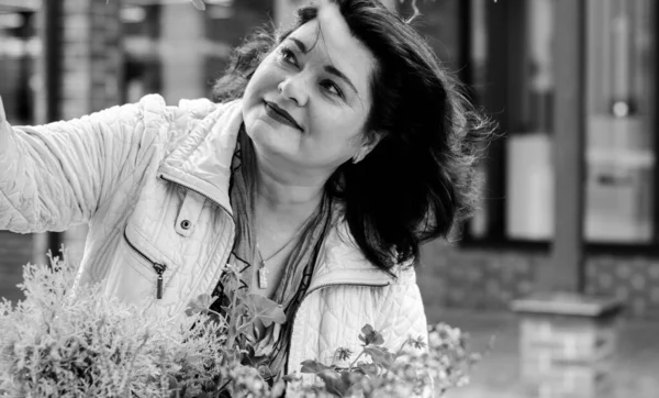 Yetişkin, iri yapılı, Amerikan ya da Avrupa görünümlü basit bir kadın şehirde hayatın tadını çıkarıyor. Fazla kilolu, ceketli ve fularlı hoş bir bayan şehrin eski bir köşesinde dolaşıyor.