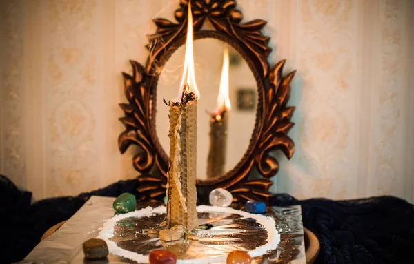 Candle for cleansing a person, magic rituals and wax casting, energy cleansing. Altar of modern witch.