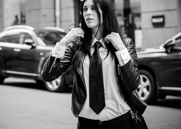 Shopping business woman in a city,Europe city streets . Lady in morern suit wearing fashionable clothes , concept of sale and shopping, outdoors.