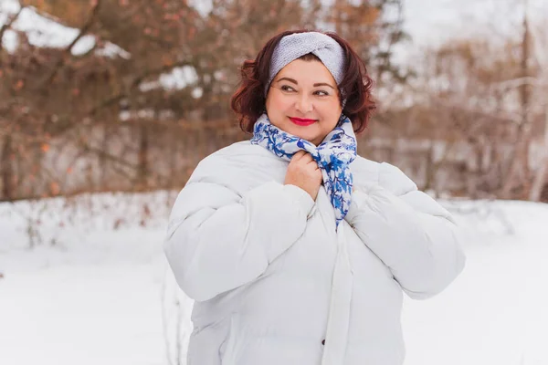 Christmas, winter holidays concept. Beautiful plus size woman walking . Love and peace for women, psychology and lifestyle of mature ladies
