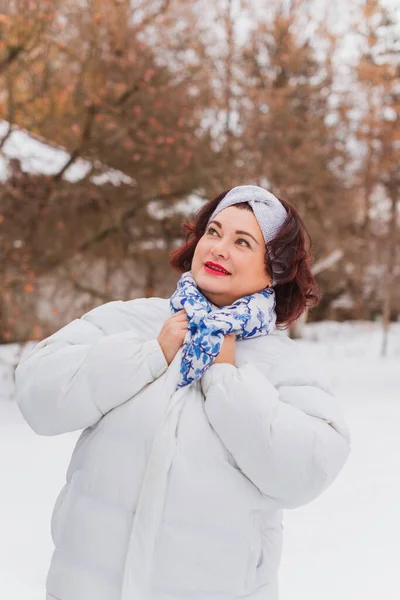 Christmas, winter holidays concept. Beautiful plus size woman walking . Love and peace for women, psychology and lifestyle of mature ladies