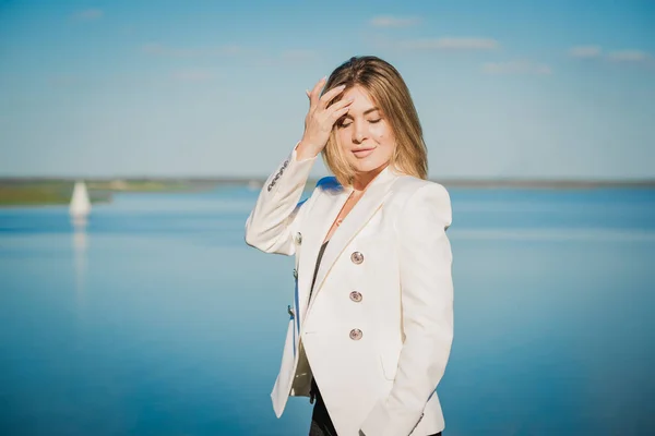 Woman in white jacket at street, woman outfit. Business and Fancy style for ladies, fashion details