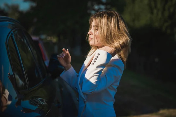 Woman in white jacket at street, woman outfit. Business and Fancy style for ladies, fashion details