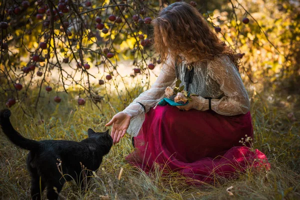 花园有黑猫的女人浪漫哥特式背景是秋天的自然 — 图库照片