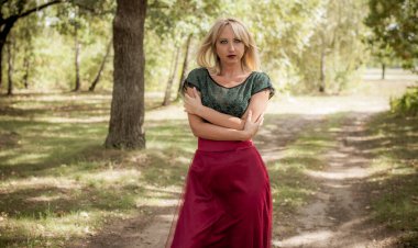 Vintage şıklığı. Klasik tonlarda portre ve dantelli etekli kadın ormanda dikiliyor ve doğa ile eğleniyor. Kendini sevme ve uyum kavramı.