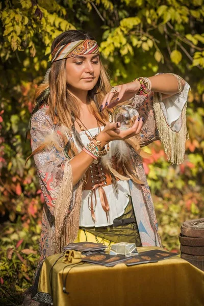 Gypsy woman fortune teller with a crystal ball, Concept of predictions, magic rituals