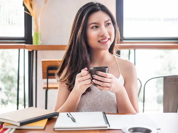 happy asia woman enjoy drinking coffee in coffee shop