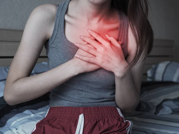 young woman with heart pain