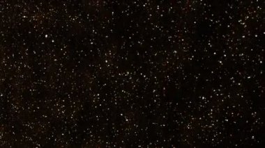 Arka plan altın tozu siyah arka plan üzerine. Parçacıkların hareket soyut.