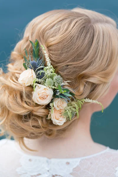 Bridal hairstyle with fresh flowers back view