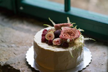 Çiçekler ve meyve ile dekore edilmiş ev yapımı düğün pastası