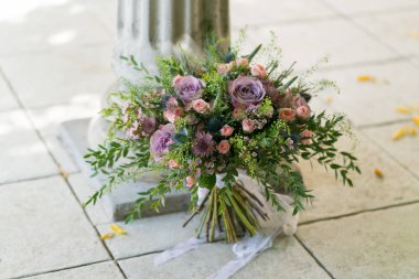 luxurious rustic bouquet on the floor near the stone column, close up clipart