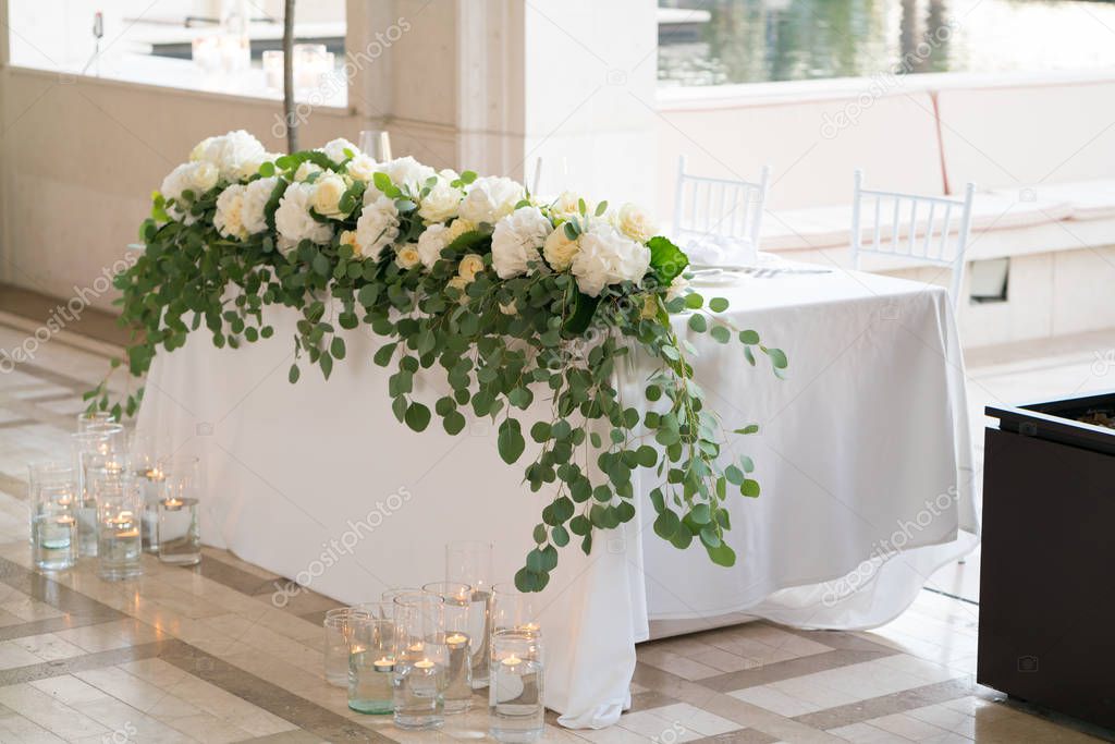 table for newlyweds served and decorated with fresh flowers