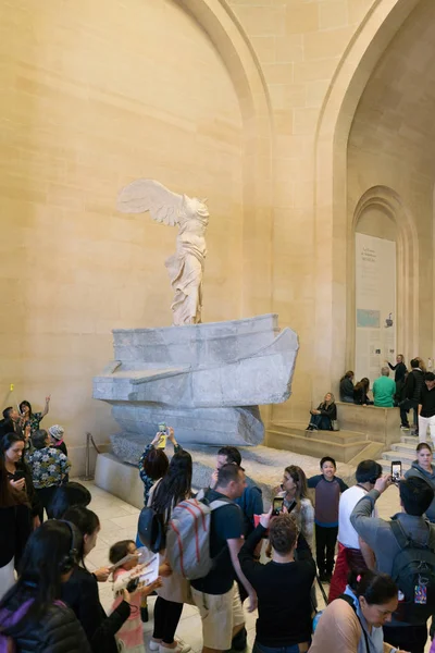 Paris, França - 31 de março de 2019: As pessoas nas escadas olham para a vitória alada de Samotrácia . — Fotografia de Stock