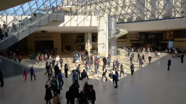 Paris, France - 31 mars 2019 : Visiteurs marchant dans le hall de la Pyramide du Louvre avec vue sur le plafond en métal et en verre — Video