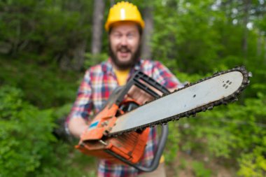 bearded lumberjack with a chainsaw makes faces clipart