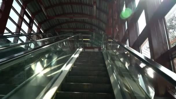 First-person view of escalator moving up on a sunny day — Stock Video