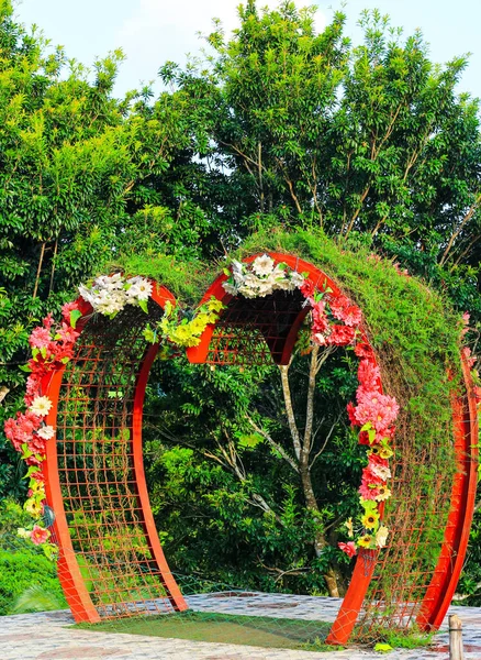 Love shape gate covered by the plant in park.