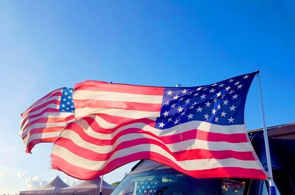 on Thanksgiving Day the flag of the United States of America flies with the wind of freedom in the blue sky and defends all American citizens