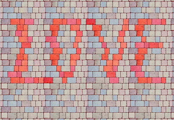 floor or wall in stone tiles decorated with the inscription: lov