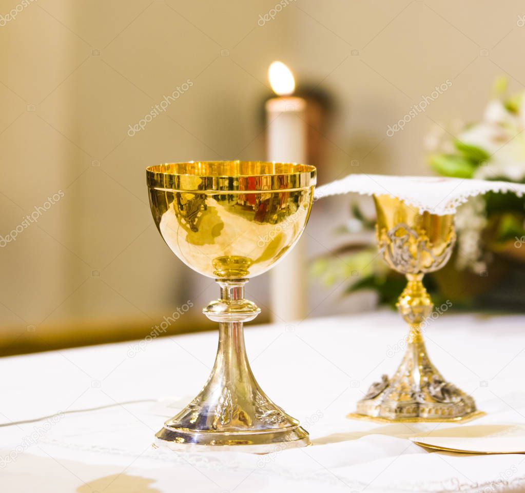 cup with wine and ciborium with host on the altar of the holy ma