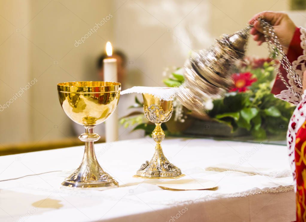 cup with wine and ciborium with host on the altar of the holy ma