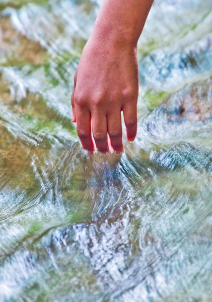 hand touching water, source of life