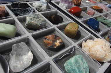 Mineral collection of assorted rocks, crystals and semi precious stones in a box