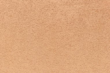 Duvardaki kırsal dış dokuların dokusu var. Şeftali rengi, kırsal dış doku boyası, arka plan fikri