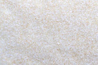 Dağınık ve pişmemiş Asya beyaz pirinç dokusu. Tahıl deseni, gıda arka planı, doku fikri