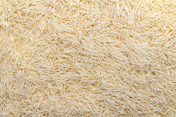 Scattered and uncooked vermicelli texture. Pastry pattern, food background, texture idea