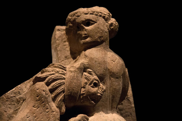 Leiden, The Netherlands - JAN 26, 2019: old stone object of a man fighting with a lion from ancient Egypt. Exhibition Gods of Egypt.