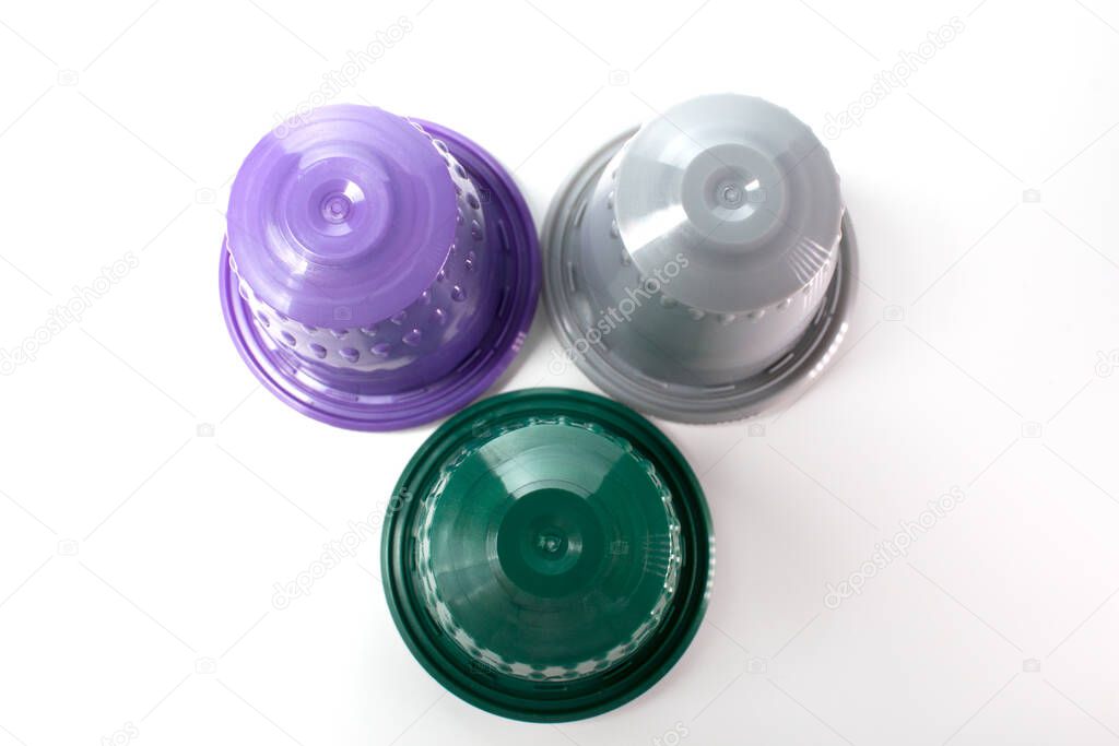 Group of different flavours of capsule coffee cups with a white background.