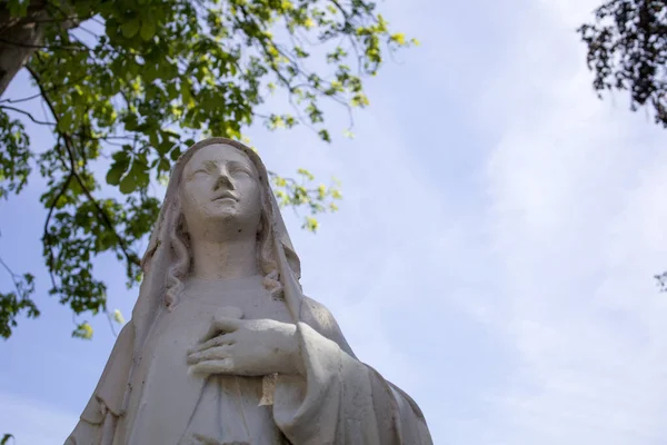 Closeup of a stone statue of the holy Maria. Religious symbol at the cemetary in Schiedam, The Netherlands.