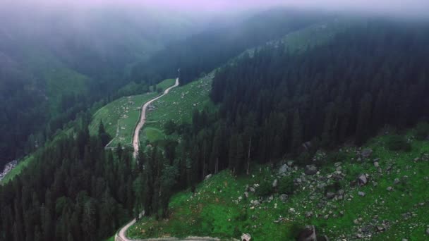 Εναέρια λήψη δρόμου που αποκλίνει προς τα βουνά κατά τη διάρκεια μουσώνων πλαισιωμένο από σύννεφα στο Manali, Himachal Pradesh, Sliding Shot — Αρχείο Βίντεο