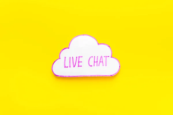 Live chat communication concept - words on yellow background top view