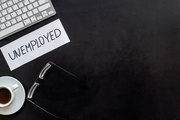 Unemployment - fired, lose job - black office desk from above copy space