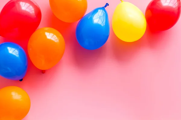 Party concept with colorful balloons on pink background top view copy space
