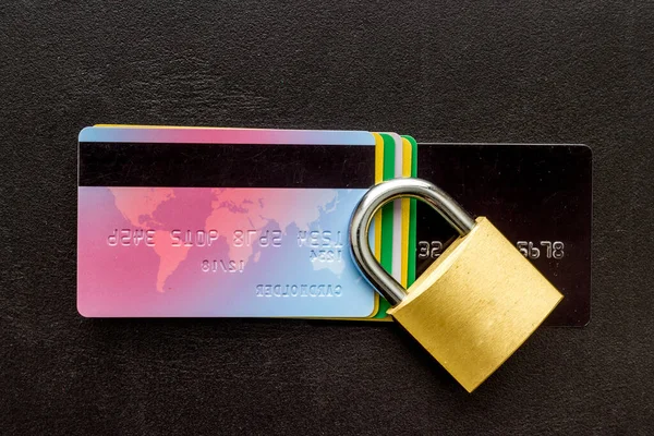 credit card with security lock on black desk top view