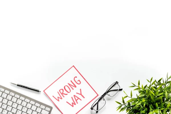 Wrong way icon on office desk - white, top view copy space