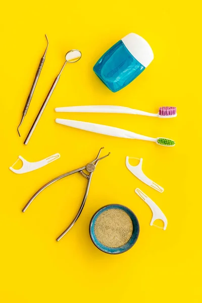 Pattern of dentist equipment. Tools, toothbrushes, dental floss flat lay, top view