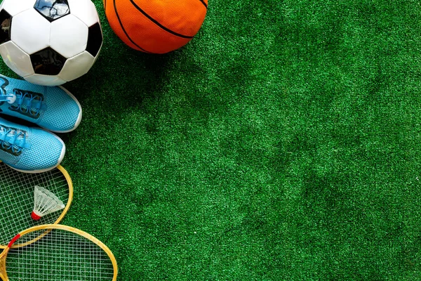 Flat lay of sport balls - football, basketball on grass top view copy space
