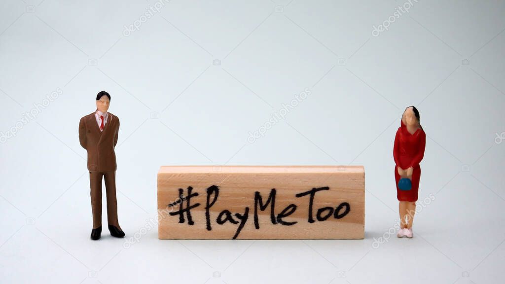 Wooden block written as #PayMeToo. Social concepts of equal pay.