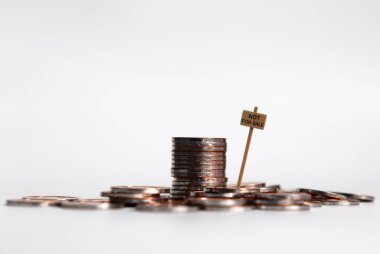 Satılık Değil mesajı olan bozuk para yığını.